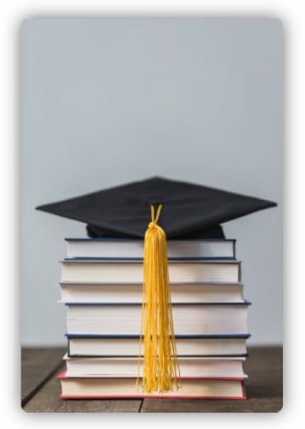 Front view of books with graduation cap on the top