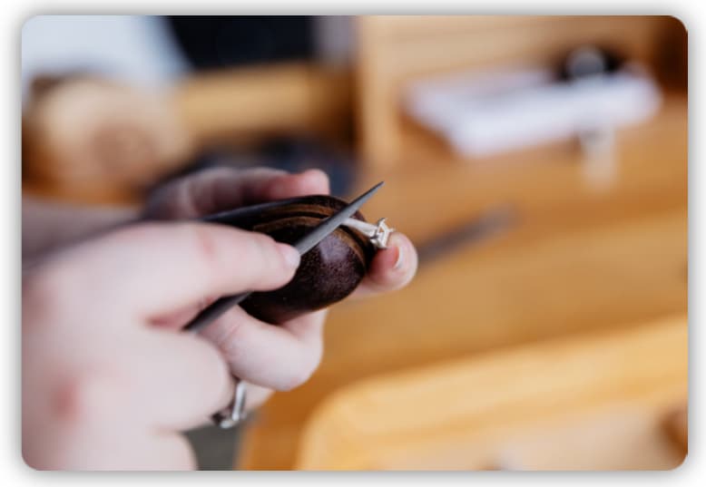 A jeweler crafting a jewelry using specialized tools